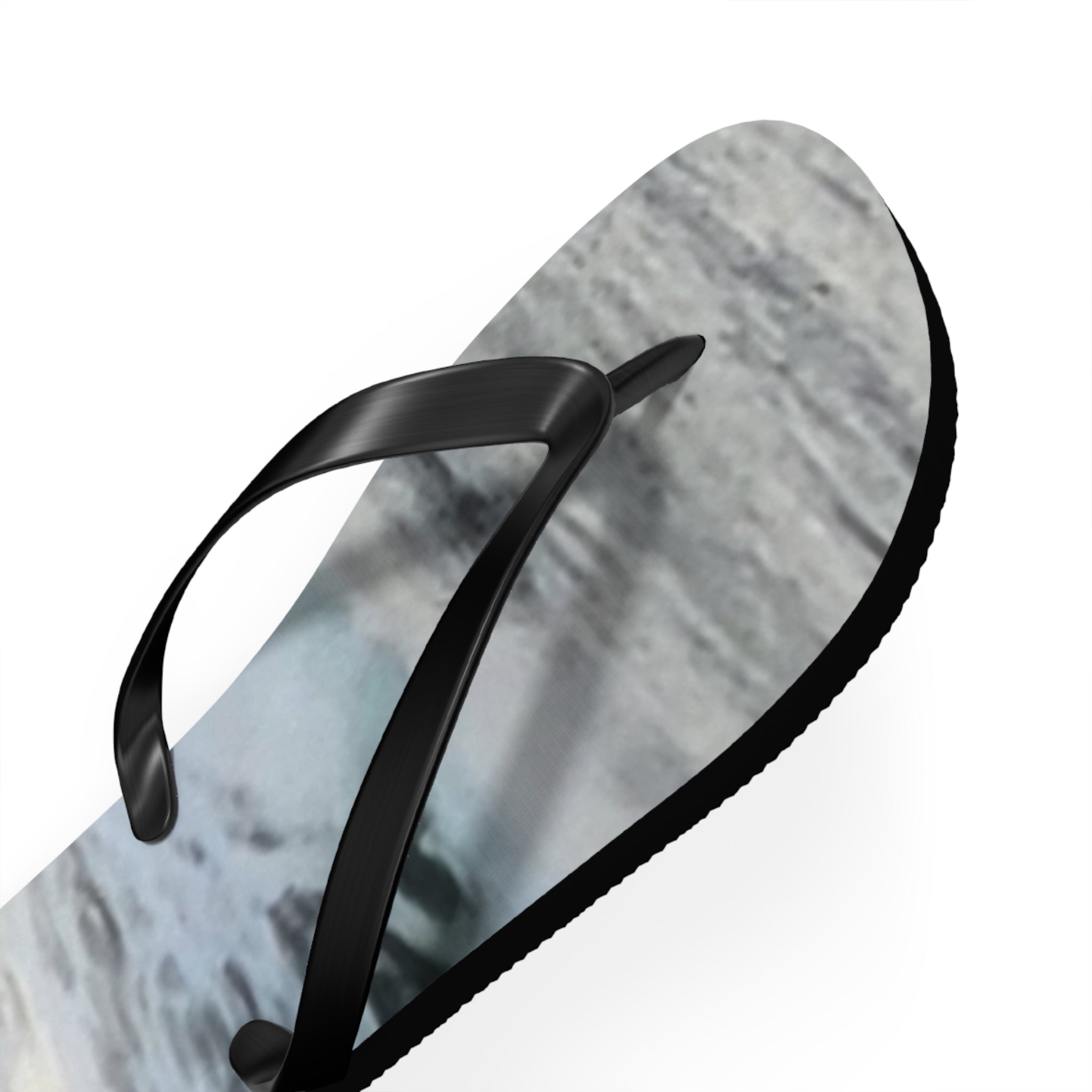 Black flip-flop with marble pattern on white background.