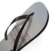 Black flip-flop with a beach scene graphic on the sole.