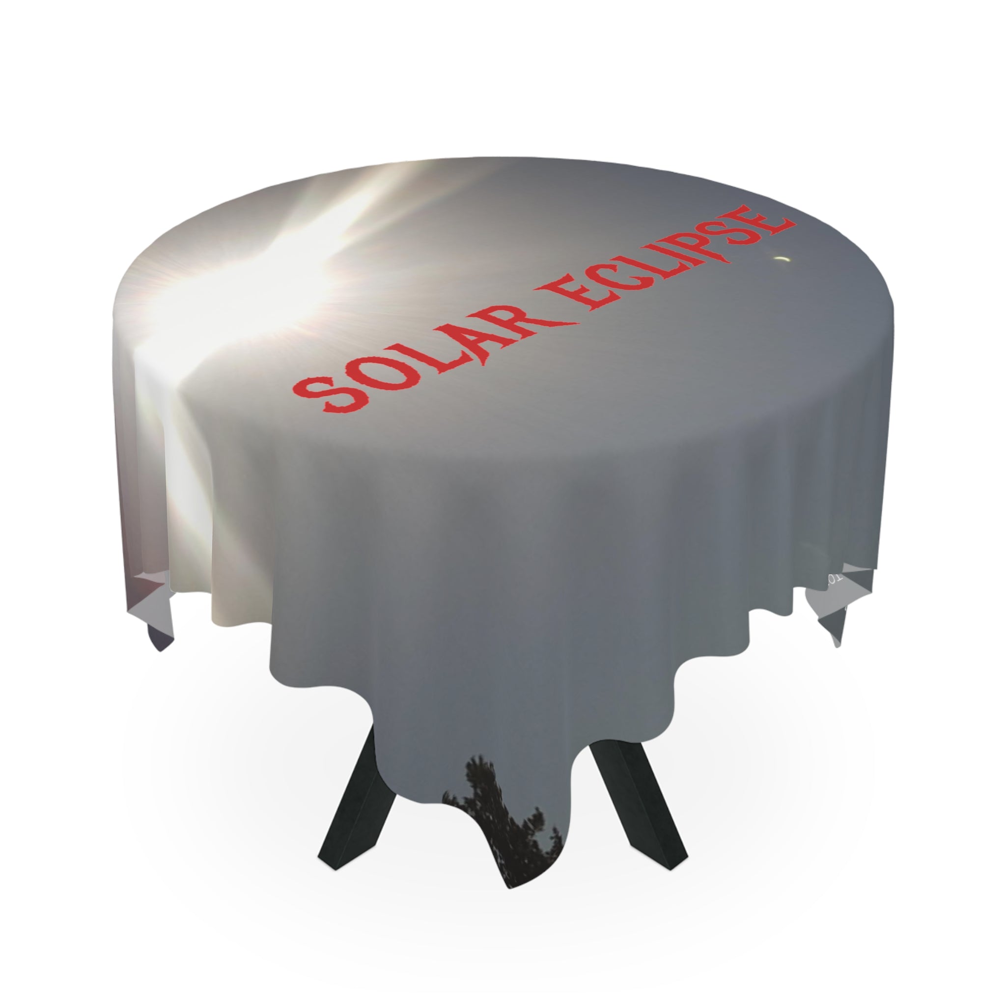 Table draped in a white cloth with "SOLAR ECLIPSE" in red text.