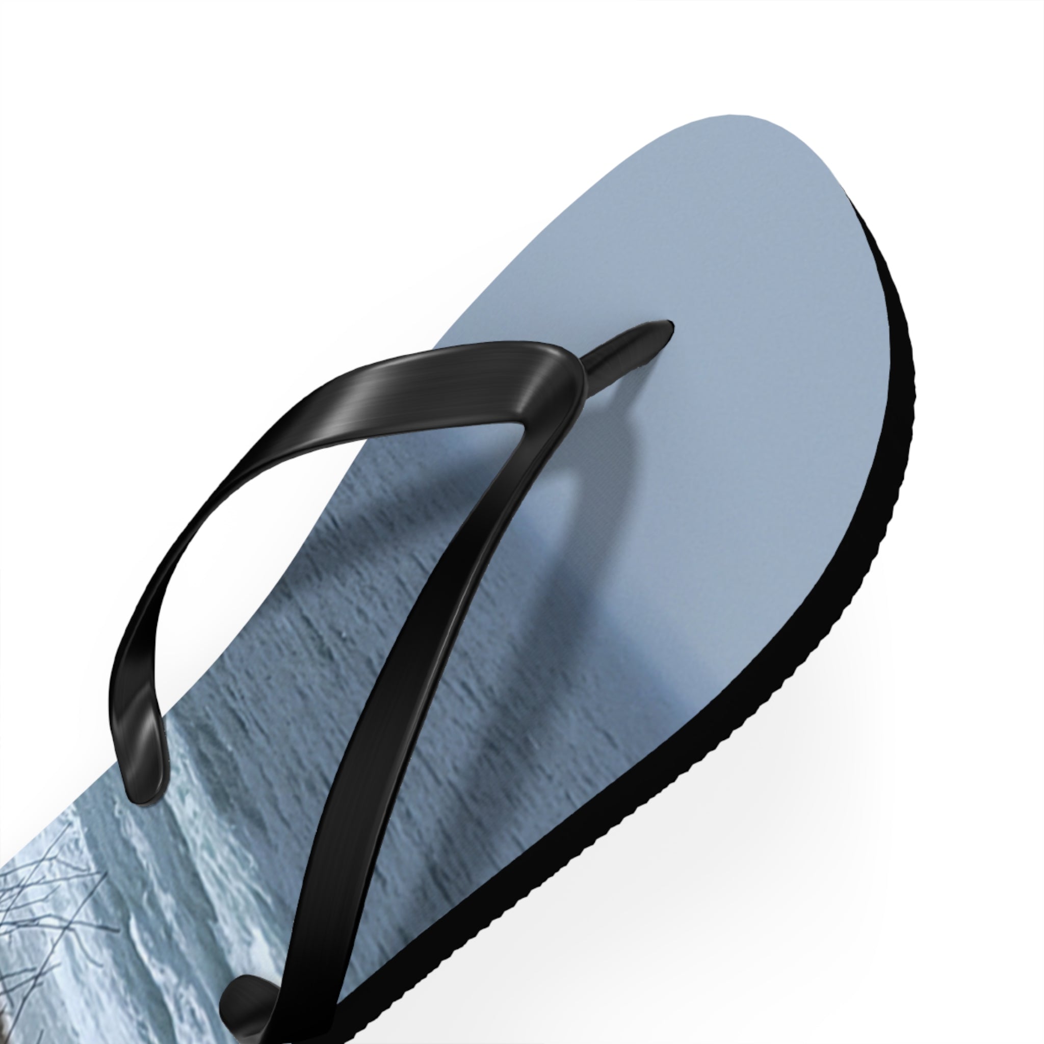 Light blue flip-flop with a close-up view of a snowy landscape on the sole.