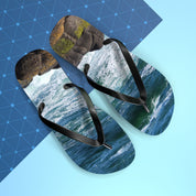 Flip-flops with a crashing wave and rock photo on blue background.