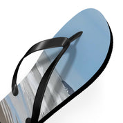 Black flip-flop with a beach landscape printed on the sole.