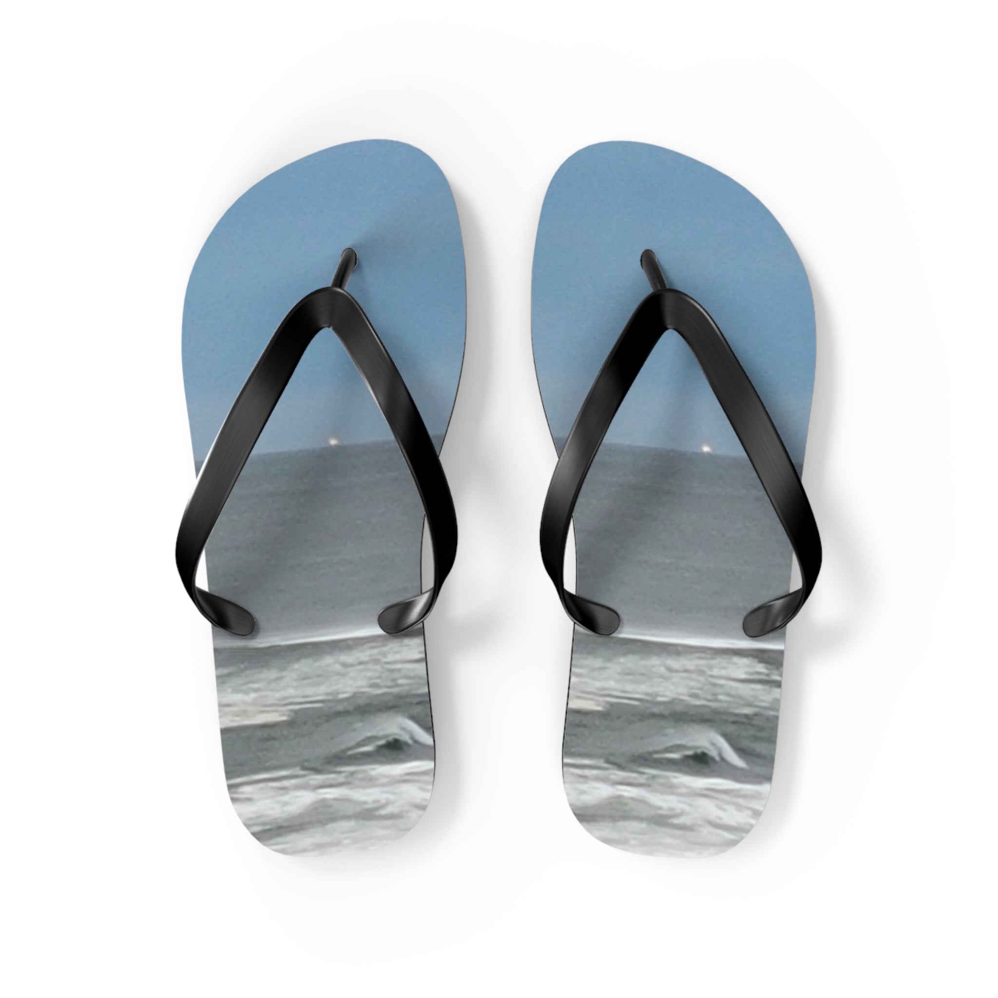 Blue flip-flops with ocean waves on a white background.