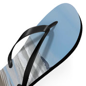Black flip-flop with a beach scene on the sole against a white background.