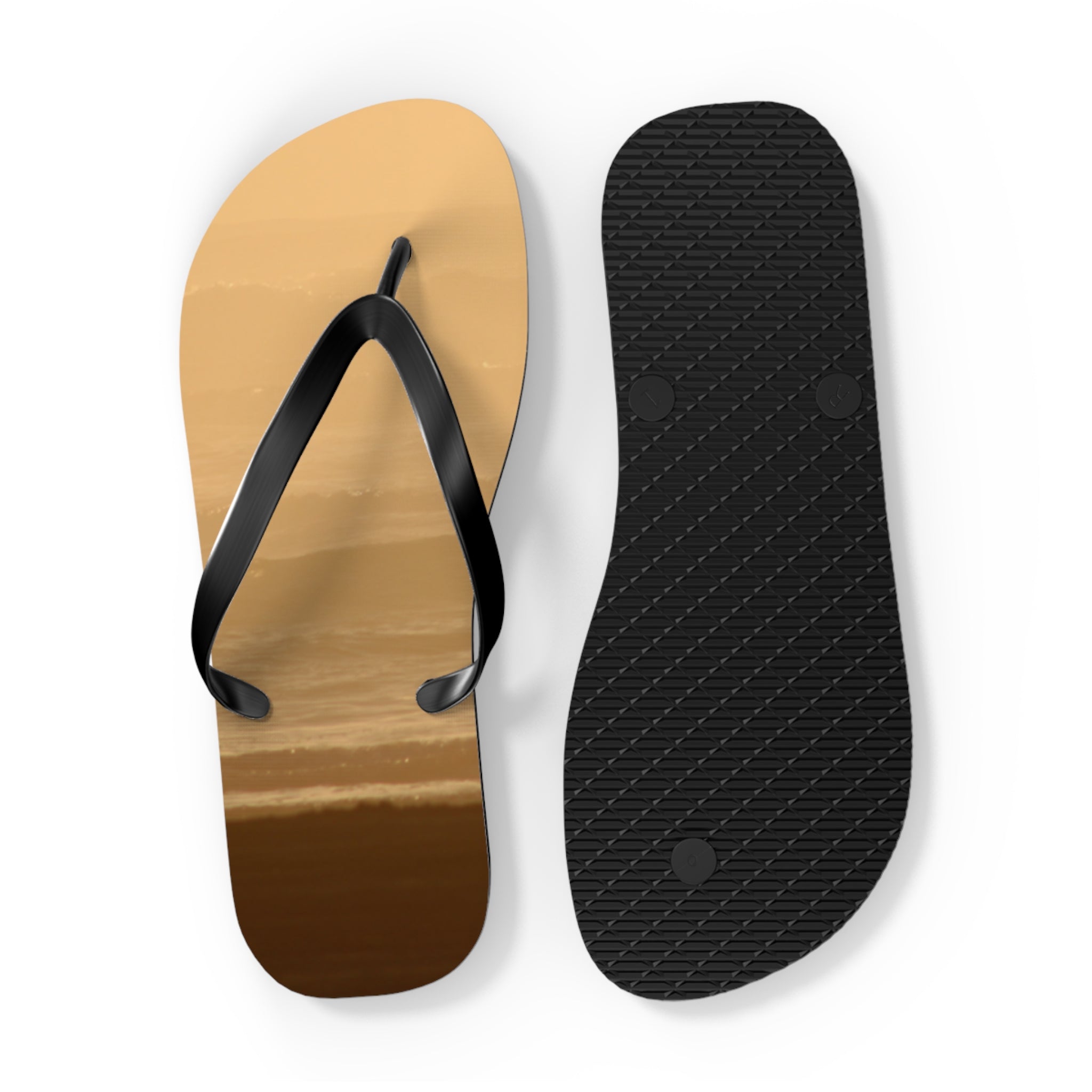 Pair of flip-flops with beach wave design on soles, white background.