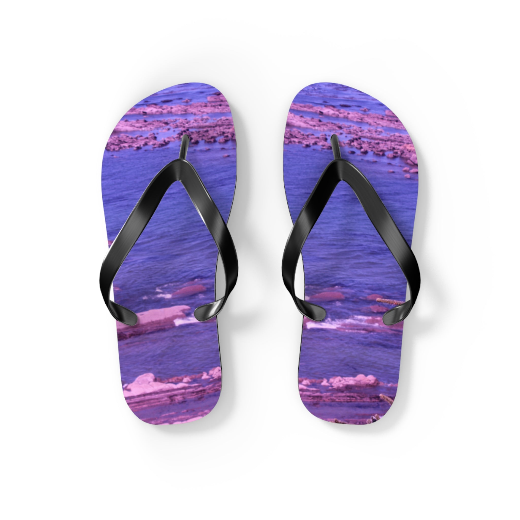 Flip flops with a purple rocky beach scene on the soles.