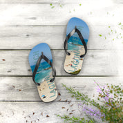 Flip-flops with "Laguna Beach" text and beach scene on weathered wood.