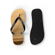 Brown flip-flops with black straps and textured black soles against a white background.