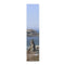 Coastal rock formations and ocean under a clear blue sky.