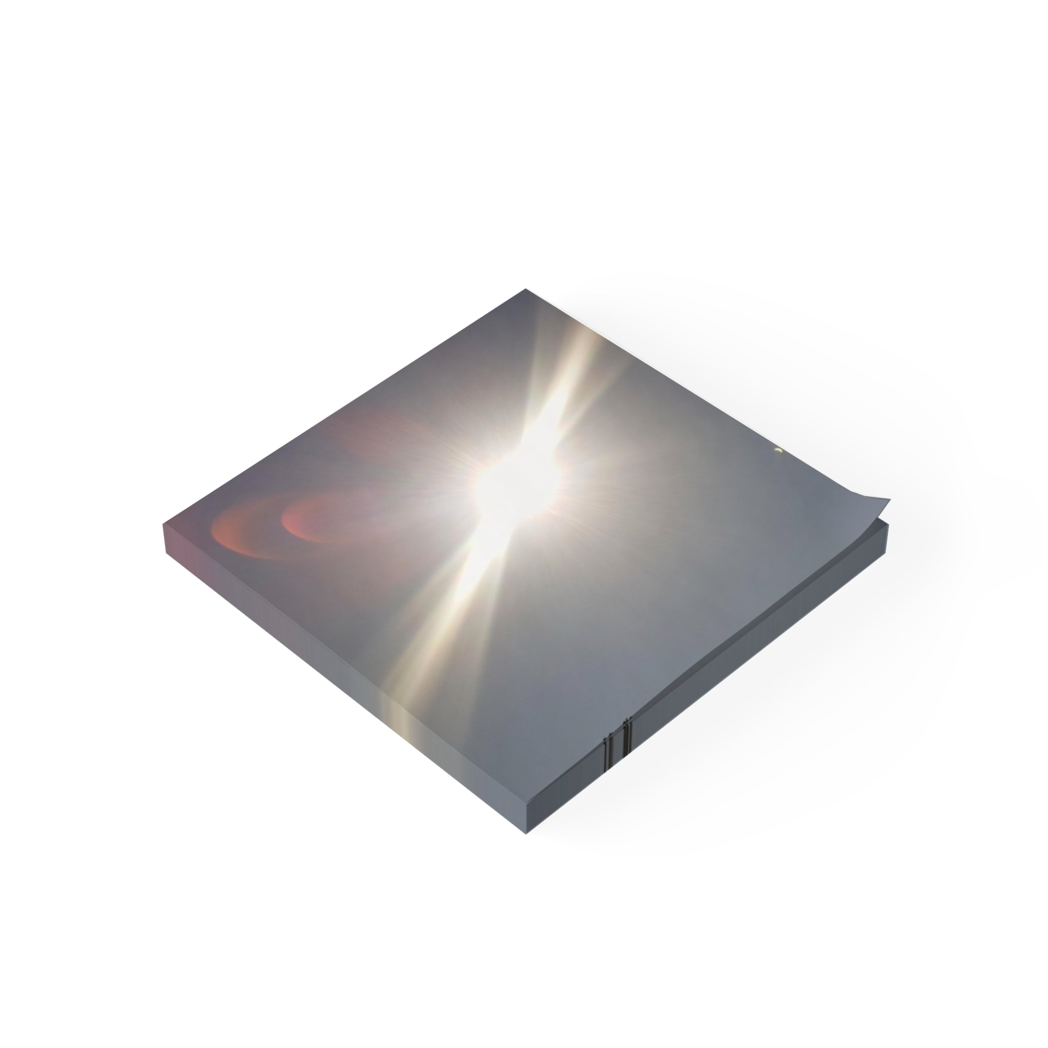 Square sticky note pad with sun flare on the cover.