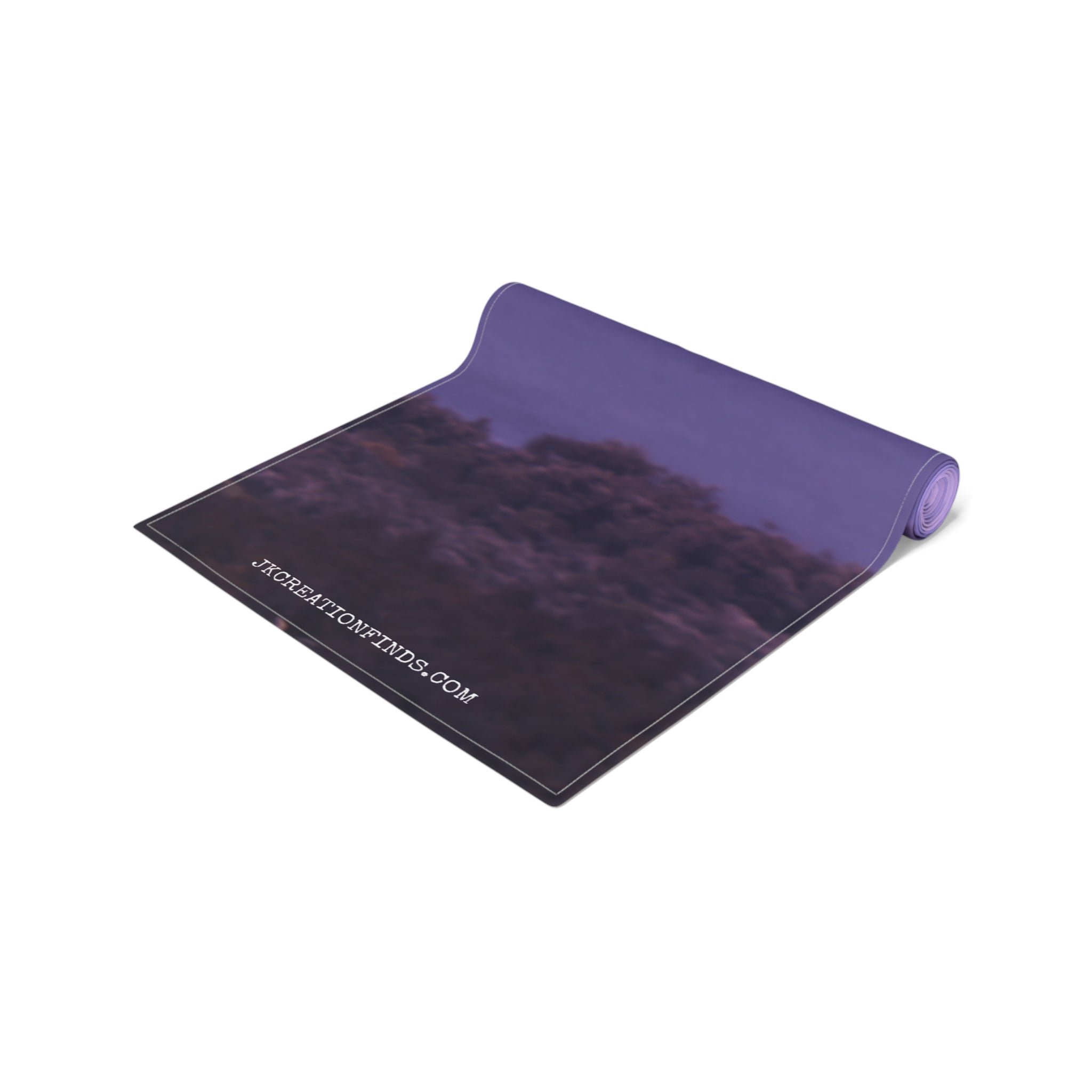Yoga mat with a purple sky and clouds, featuring website URL.