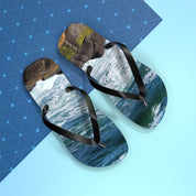 Flip-flops with ocean waves and rock print on a blue grid background.