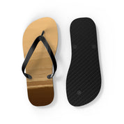 Flip-flops with a beach sunset design on one sole and black textured sole.