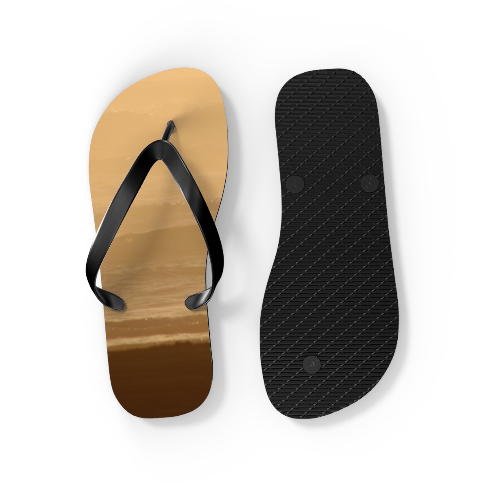 Flip-flops with a beach sunset design on one sole and black textured sole.