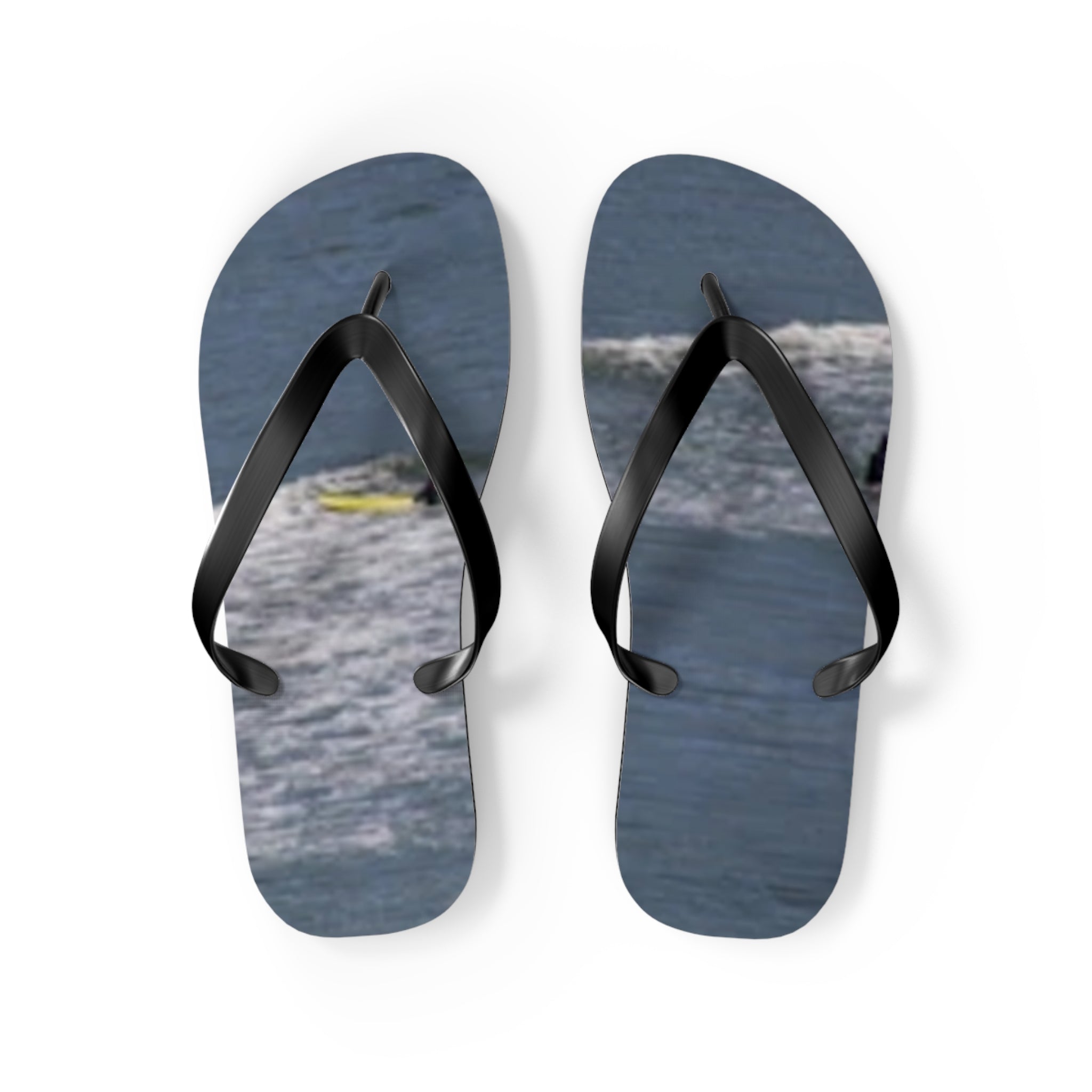 Blue flip-flops with waves and a surfer graphic on white background.