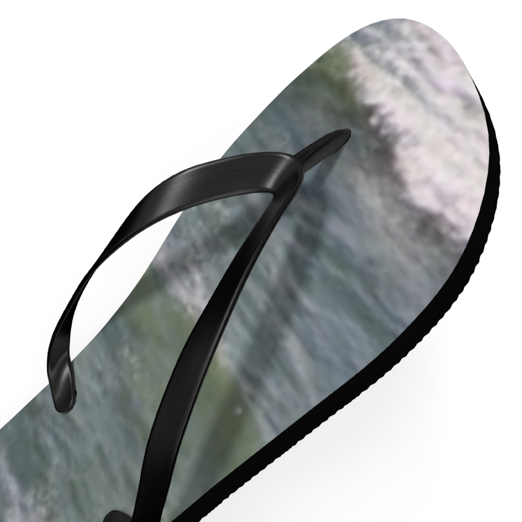Black flip-flop with a wave pattern on the sole.