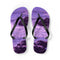 Purple flip-flops with a rocky ocean wave design on a white background.