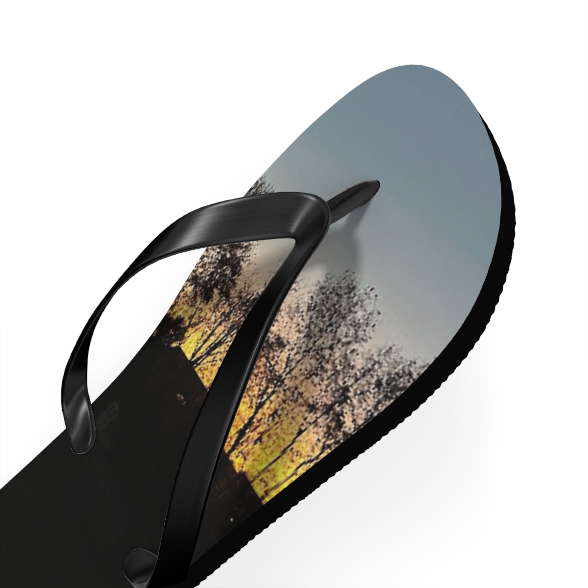 Black flip-flop with a sunset landscape printed on the sole.