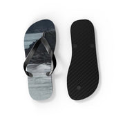 Black flip-flops with a scenic beach landscape on the footbeds.