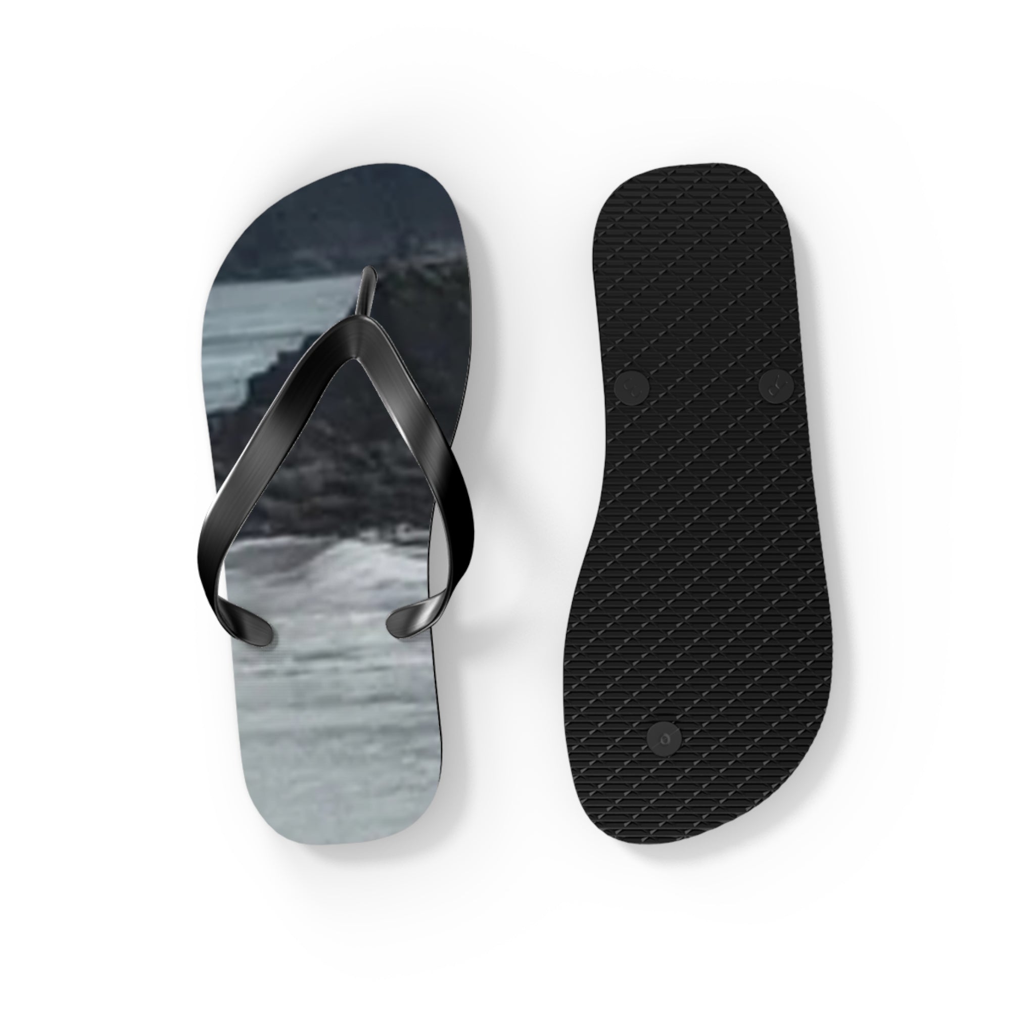 Black flip-flops with a scenic beach landscape on the footbeds.