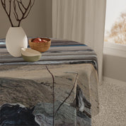 Round tablecloth with abstract wood grain pattern and decorative bowl.
