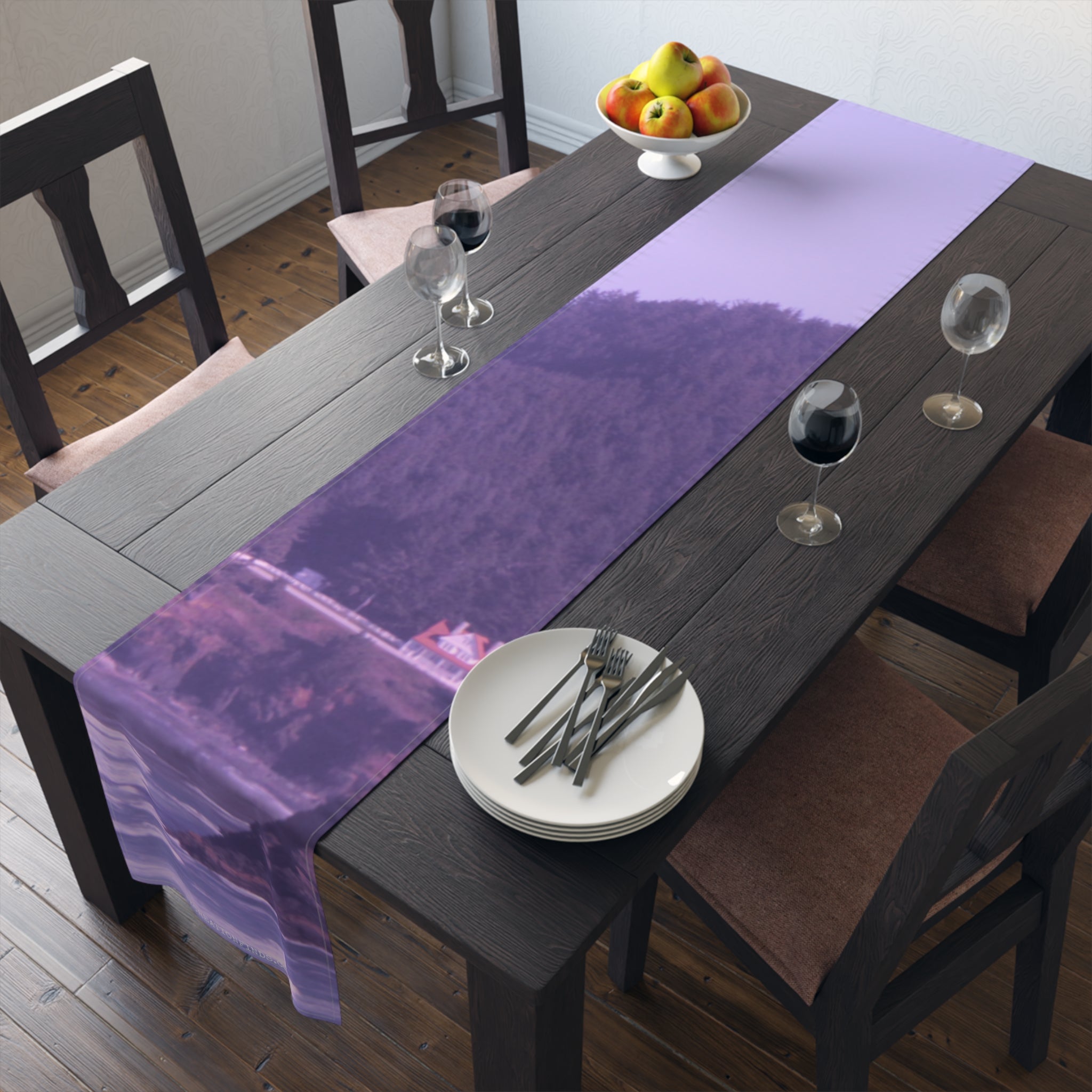 Purple abstract landscape table runner on a dining table with place settings.
