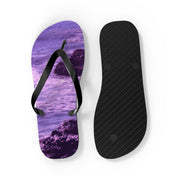 Purple and black flip-flops with a rocky beach design.