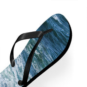 Black flip-flop with a close-up ocean wave pattern.