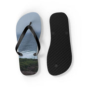 Flip-flops with a scenic ocean view and a textured sole.