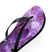 Flip-flops with a blurry purple floral pattern and black straps.