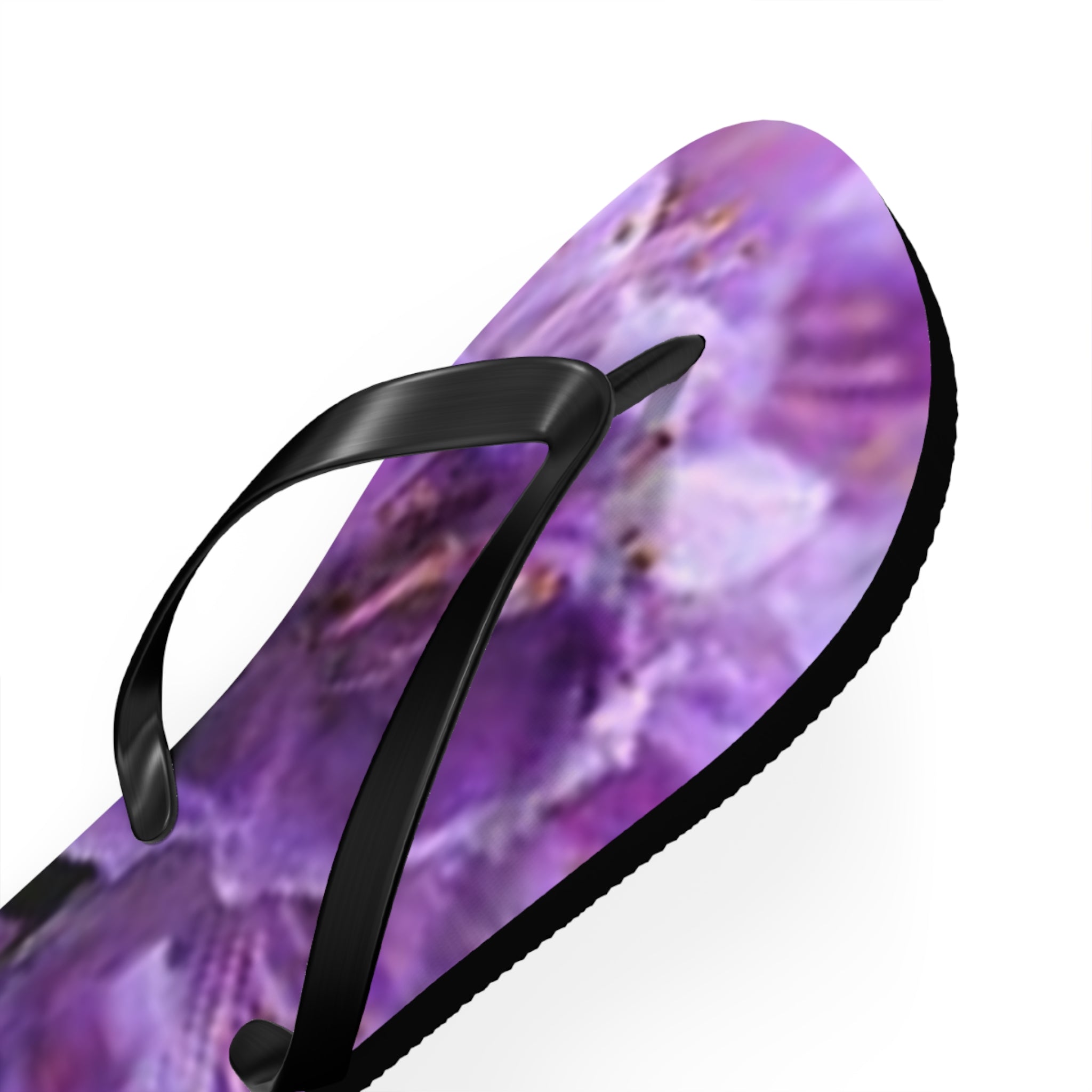 Flip-flops with a blurry purple floral pattern and black straps.
