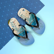 Flip-flops with "LAGUNA BEACH" text on a blue grid background.
