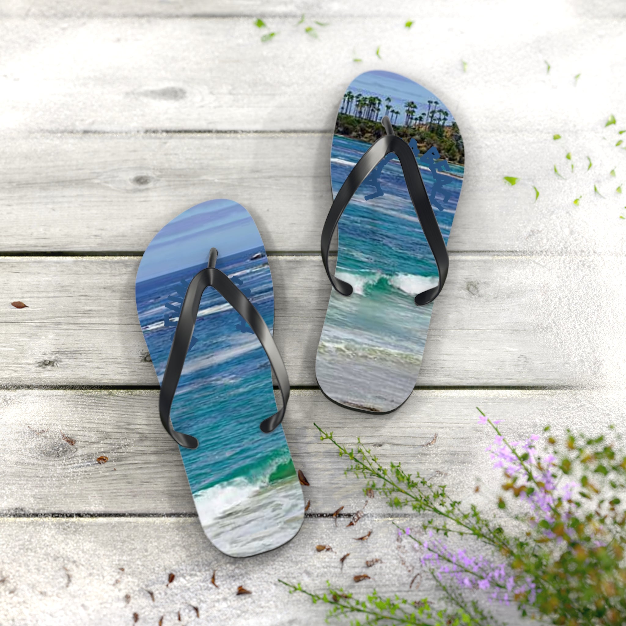 Flip-flops with a tropical beach scene on a wooden deck.