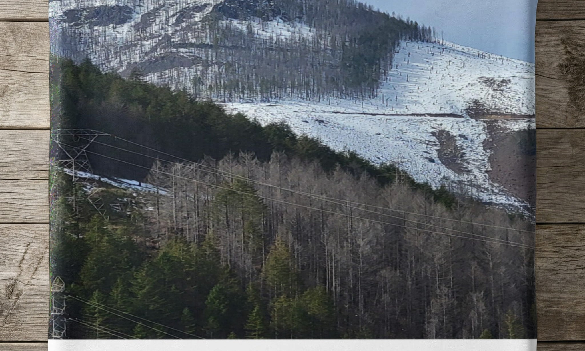 Mountain landscape with power lines and text "KNOW THERE'S A SASQUATCH".