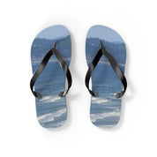 Blue ocean wave flip flops on a white background.