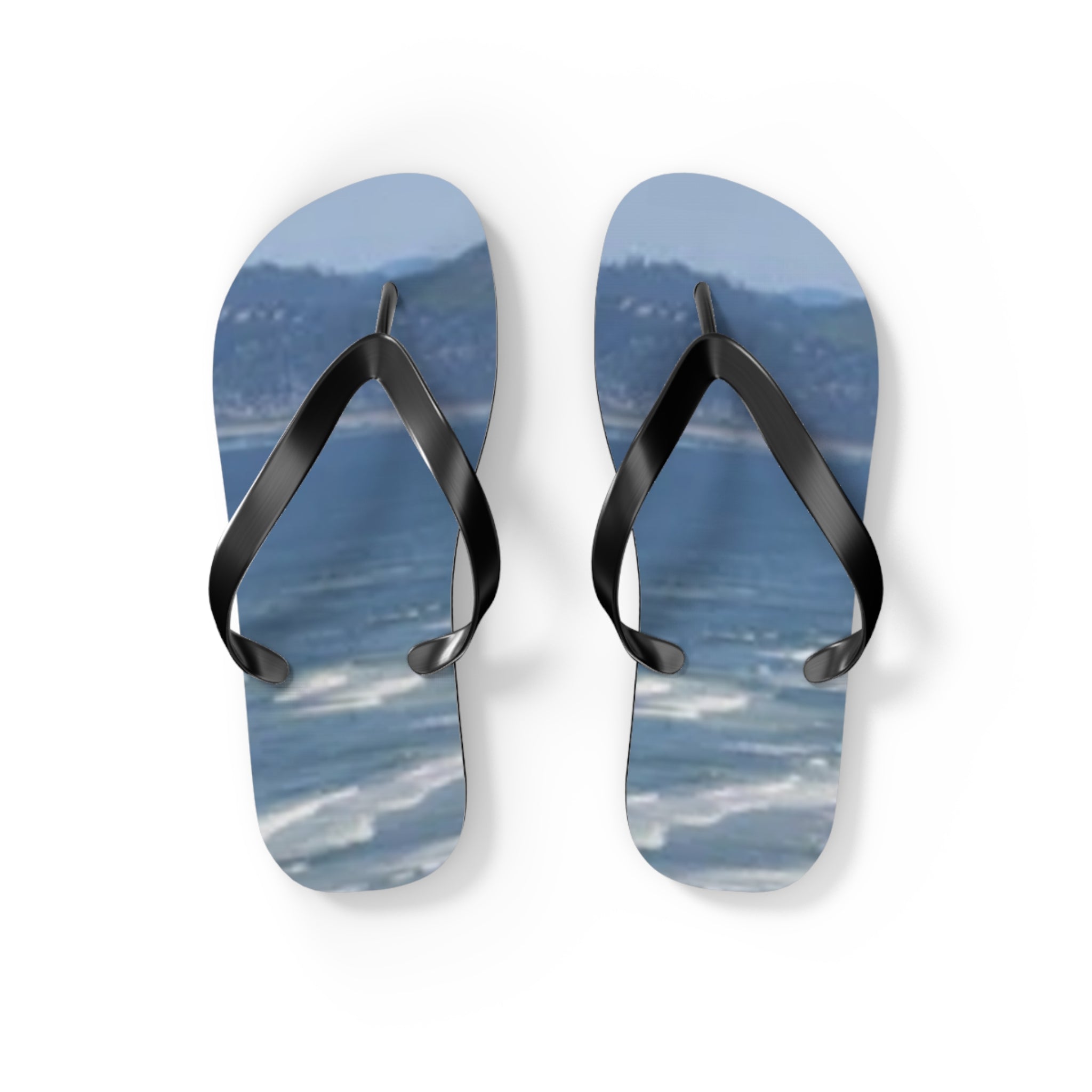 Blue ocean wave flip flops on a white background.