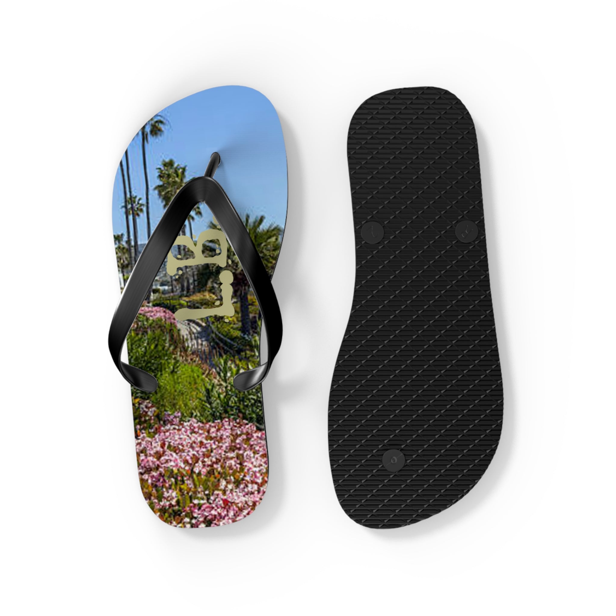 Flip-flops with a beach scene and palm trees on one sole, black sole on other.