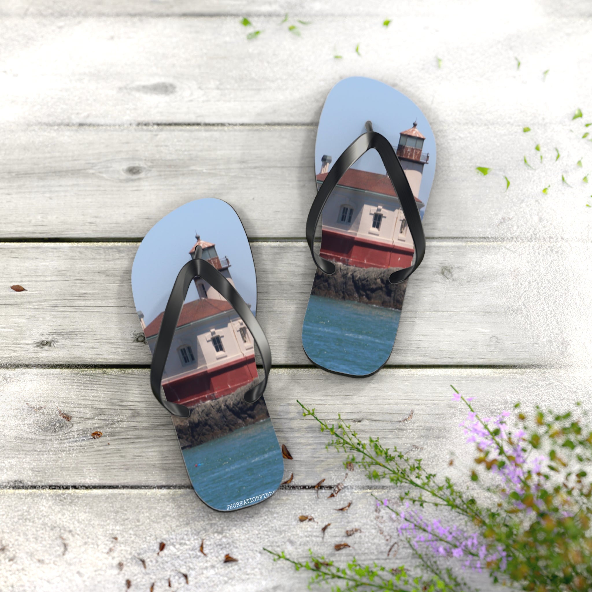 Flip-flops with a lighthouse on a rocky shore design.