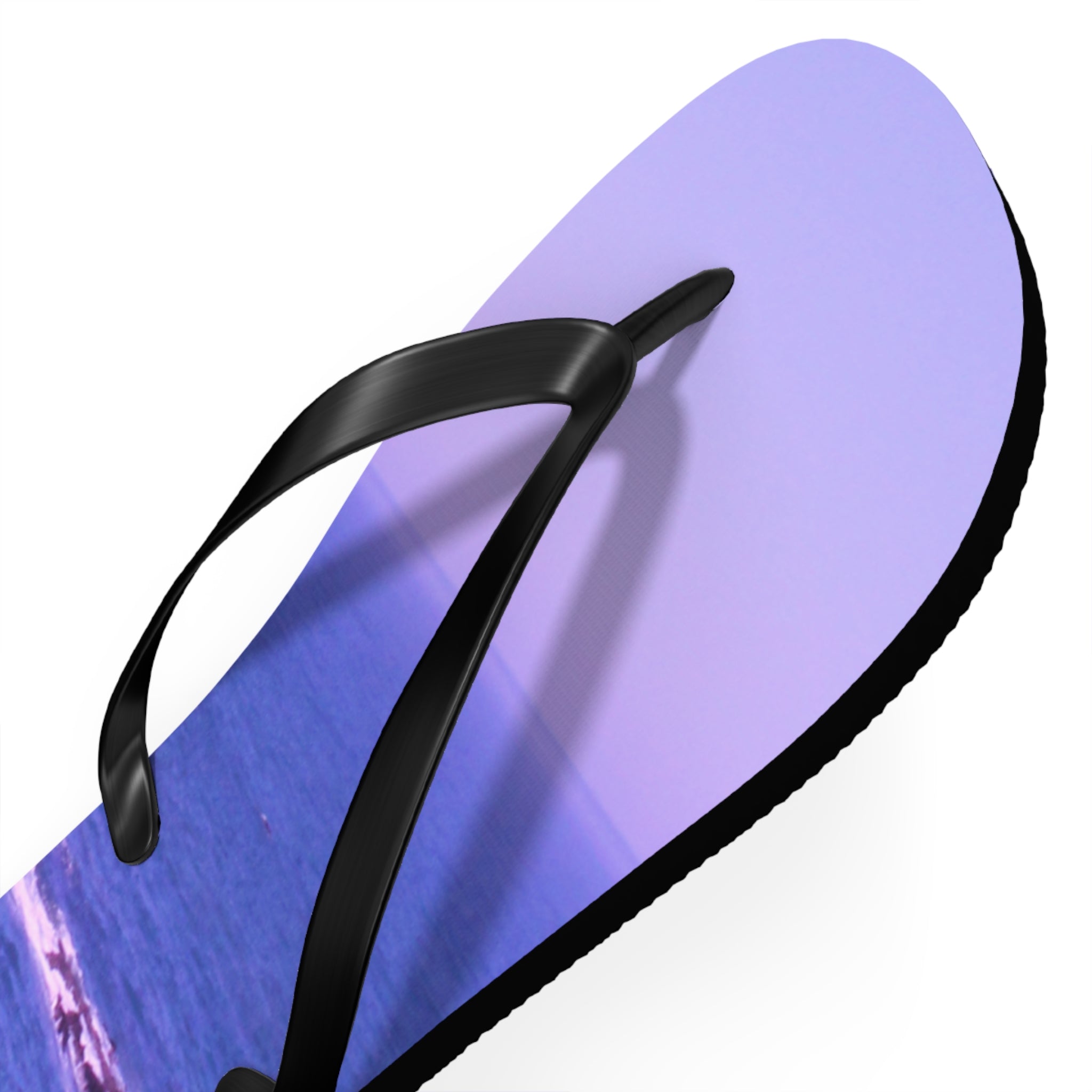 Purple flip-flop with black straps and ocean beach scene on sole.