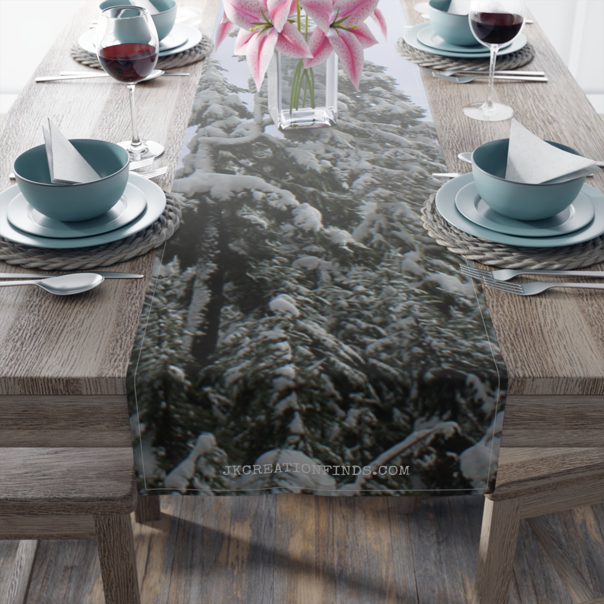 Winter scene table runner with snow-covered evergreens.