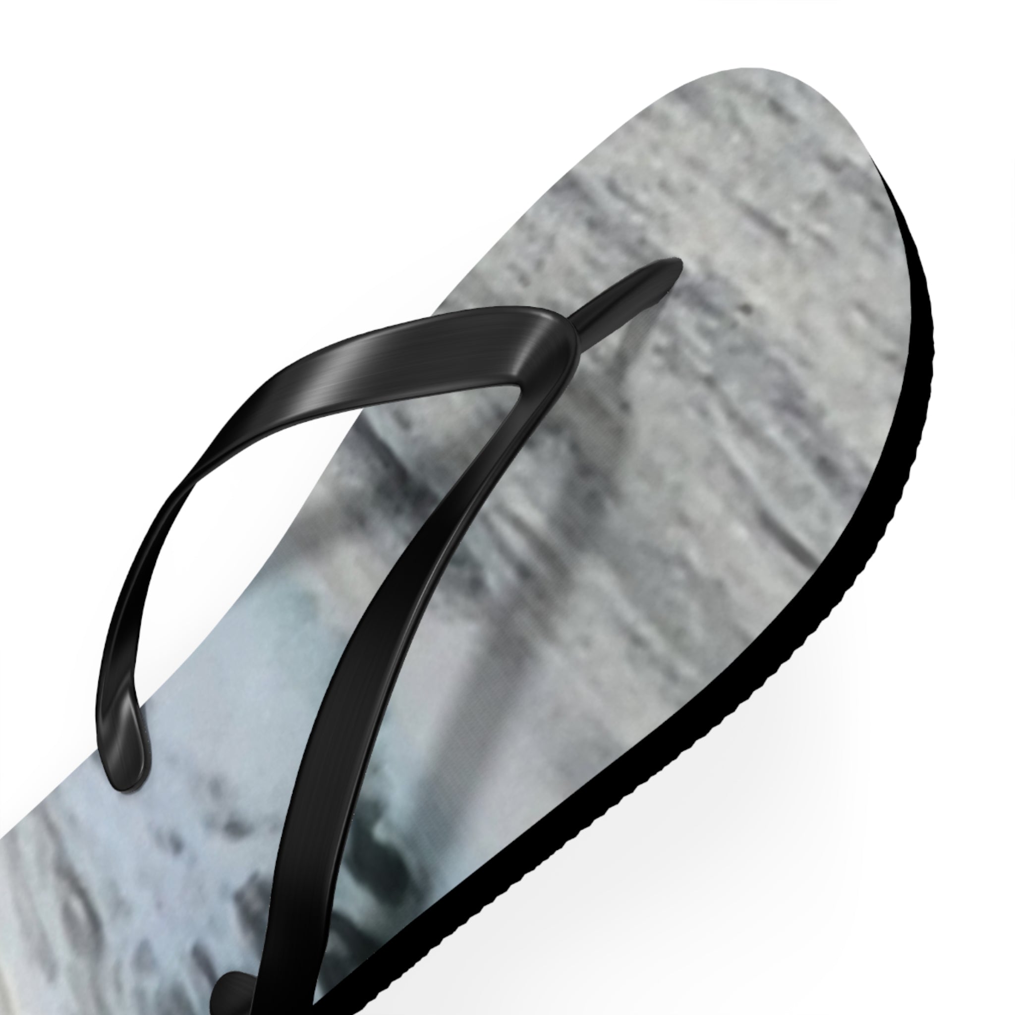 Black flip-flop with a grey and white textured sole.