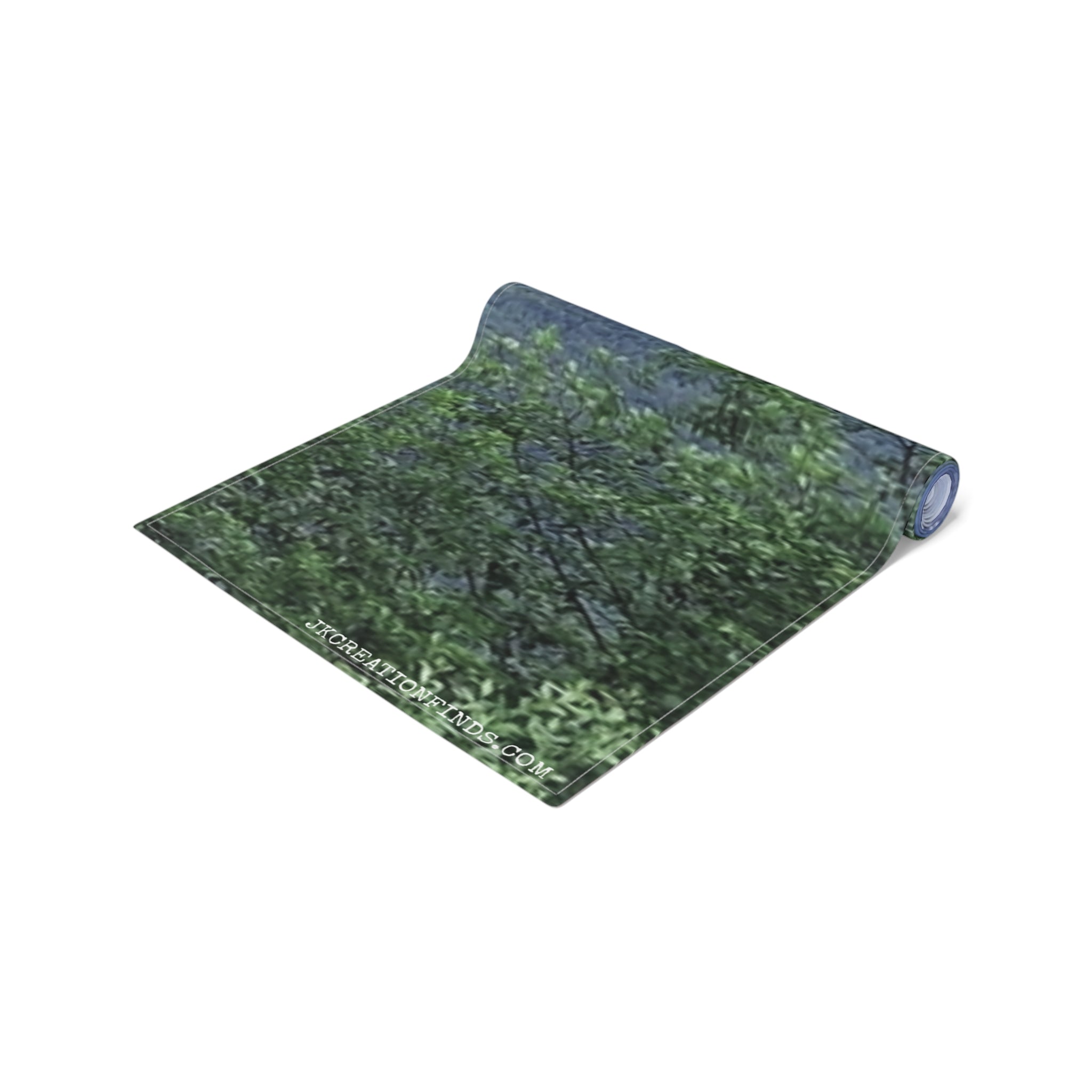 Rolled yoga mat with green foliage pattern and "JKCREATIONFINDS.COM" text.