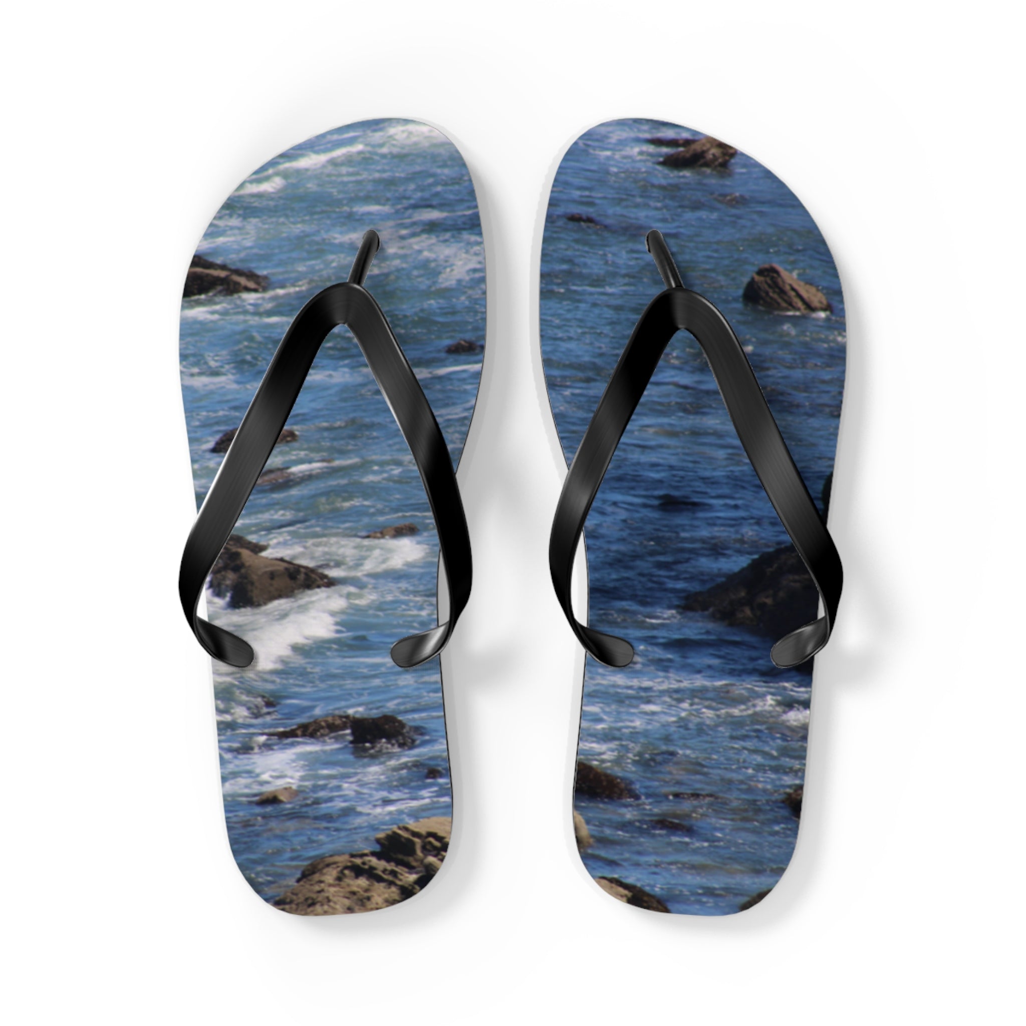 Flip-flops with a seascape design of waves and rocks.