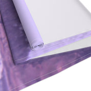 Rolled fabric with a blurred purple and white floral pattern.