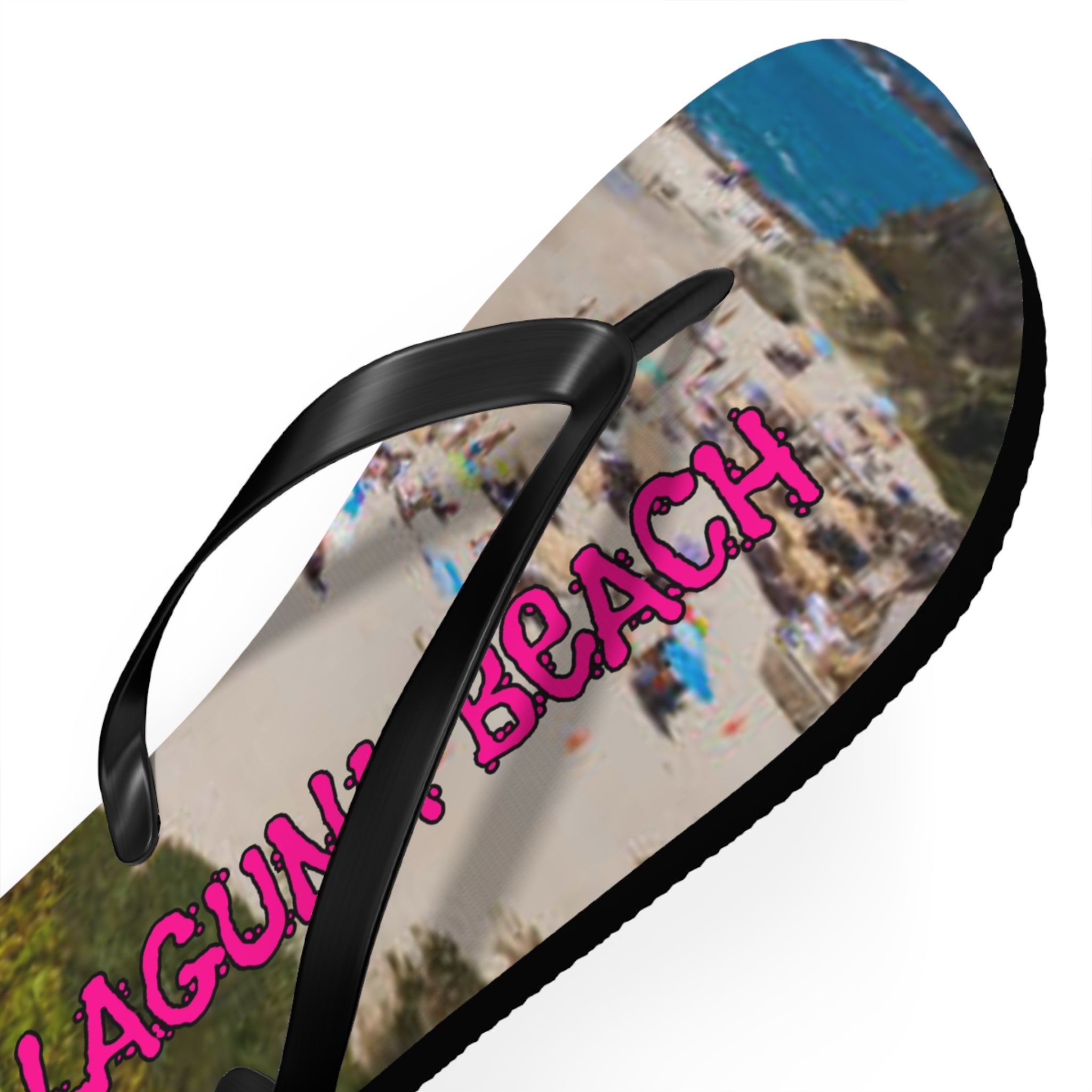 Black flip-flop with "Laguna Beach" in pink graffiti text.