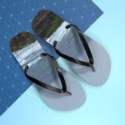 Flip-flops with a waterfall scene on a blue patterned background.