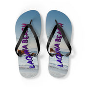 Laguna Beach flip-flops with ocean and rock background.