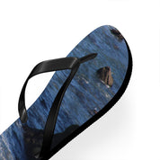 Flip-flop with ocean wave pattern and black straps on white background.
